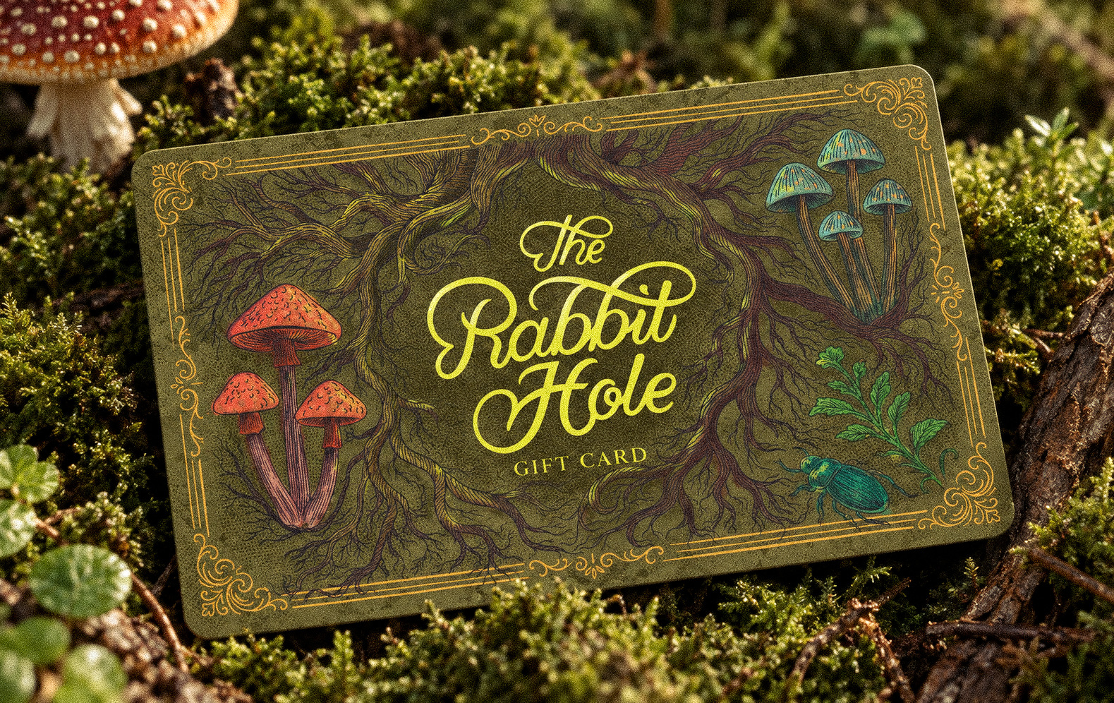 The Rabbit Hole illustrated gift card photographed in a mossy woodland setting